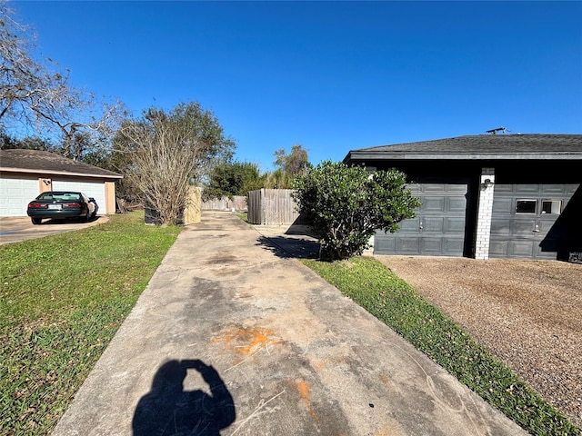 view of side of home featuring a garage and a lawn