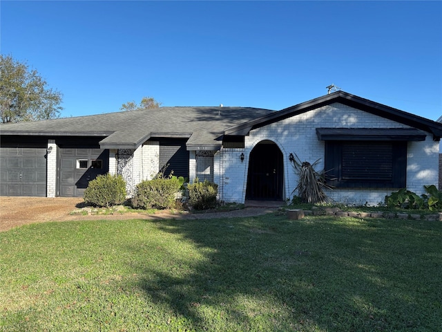 ranch-style house featuring a garage and a front lawn