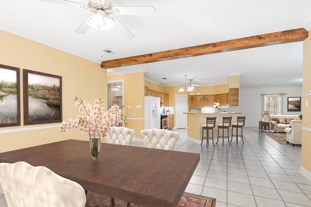 dining area with light tile patterned floors and ornamental molding