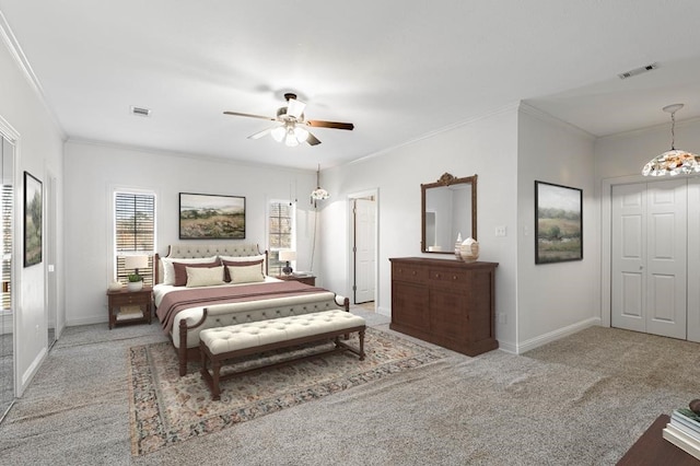 carpeted bedroom featuring crown molding and ceiling fan with notable chandelier