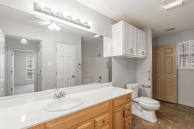 full bathroom featuring ceiling fan, vanity, tub / shower combination, and toilet