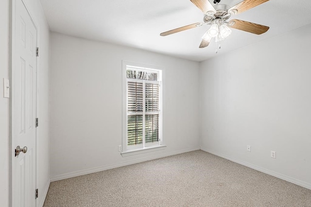 carpeted spare room featuring ceiling fan and a wealth of natural light