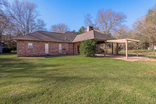 rear view of property with a pergola and a lawn