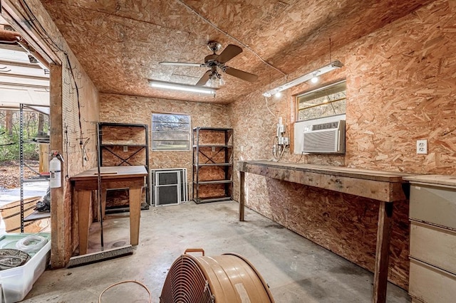 miscellaneous room featuring a workshop area, ceiling fan, cooling unit, and concrete flooring