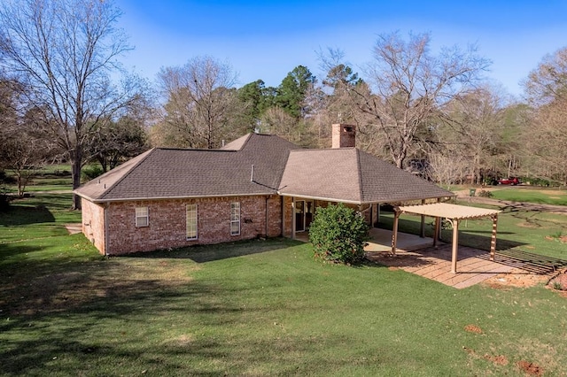 back of property with a yard and a patio