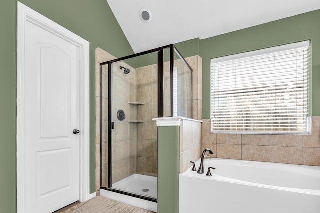 bathroom with independent shower and bath and vaulted ceiling