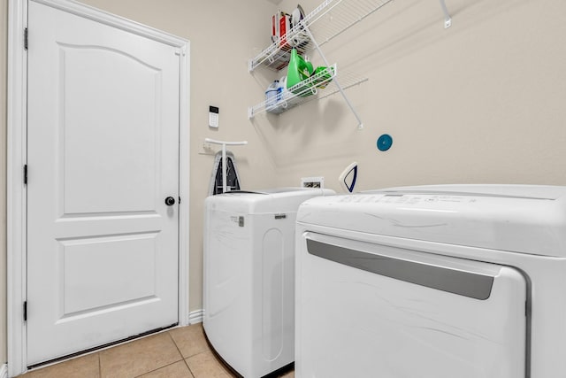 laundry room with light tile patterned floors and washer and dryer