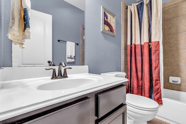 full bathroom featuring shower / bath combo with shower curtain, vanity, and toilet