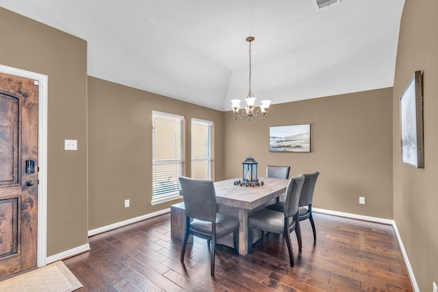 dining room featuring dark hardwood / wood-style flooring, lofted ceiling, and a notable chandelier