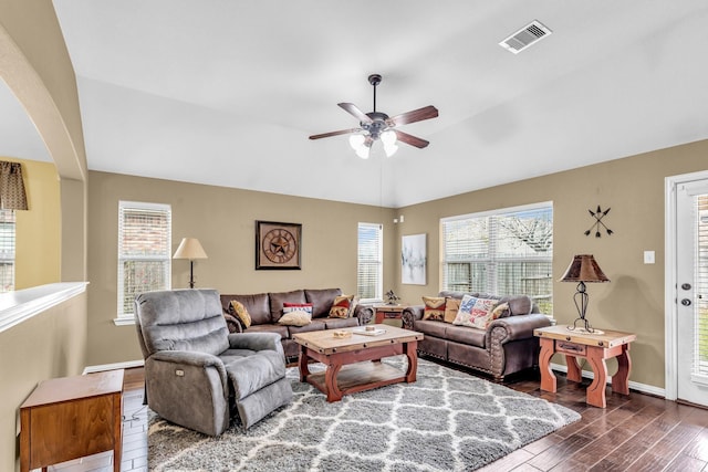 living room with a wealth of natural light, ceiling fan, and dark hardwood / wood-style flooring