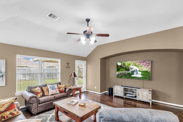 living room featuring dark hardwood / wood-style flooring, vaulted ceiling, and ceiling fan