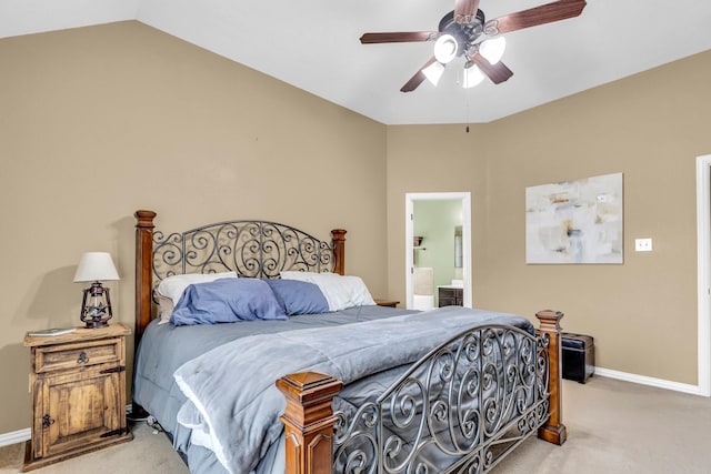 bedroom with connected bathroom, light colored carpet, and ceiling fan