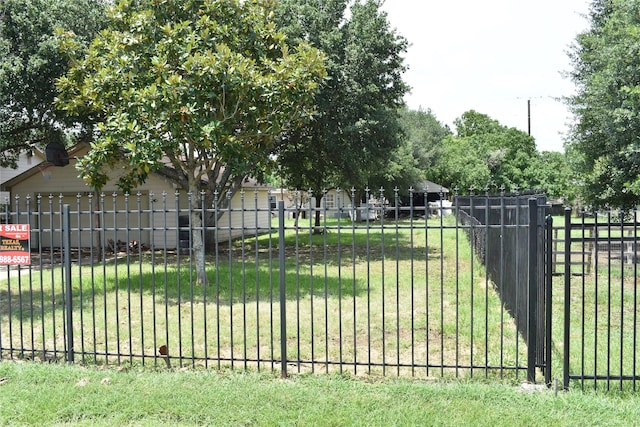 view of gate featuring a yard