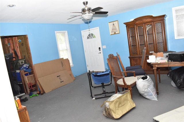 interior space with ceiling fan