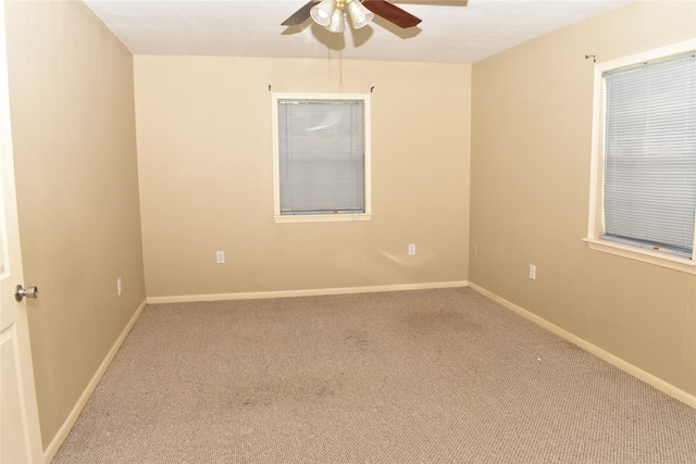 carpeted spare room with ceiling fan