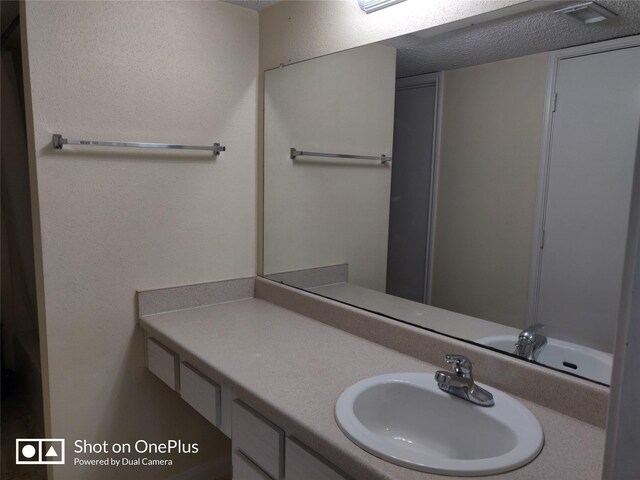 bathroom featuring vanity and a textured ceiling