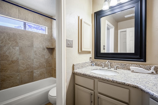 full bathroom featuring vanity, toilet, and tiled shower / bath