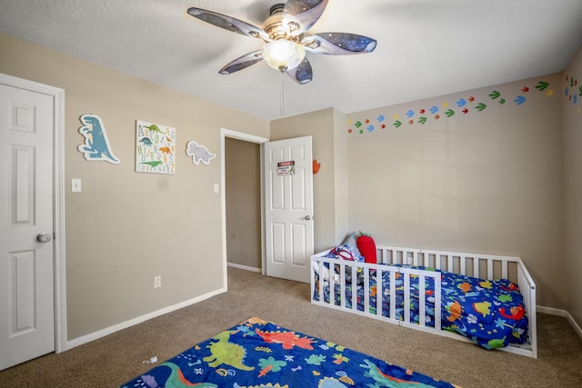 bedroom featuring carpet, a crib, and ceiling fan