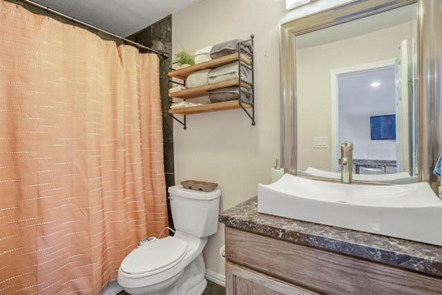 bathroom with walk in shower, vanity, and toilet