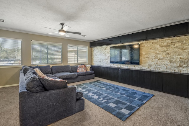 living room featuring ceiling fan, crown molding, carpet, and a textured ceiling