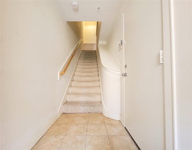 staircase with tile patterned floors