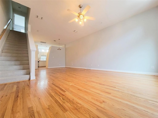 unfurnished living room featuring light hardwood / wood-style floors and ceiling fan