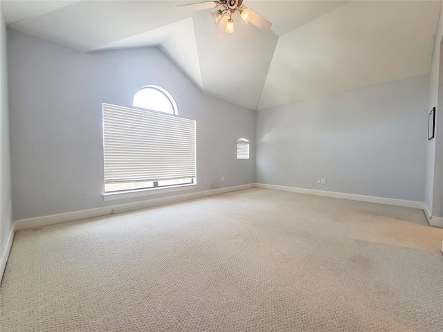 spare room with carpet floors, vaulted ceiling, and ceiling fan