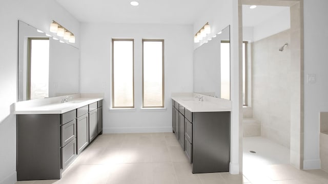 bathroom with a tile shower, tile patterned floors, and vanity