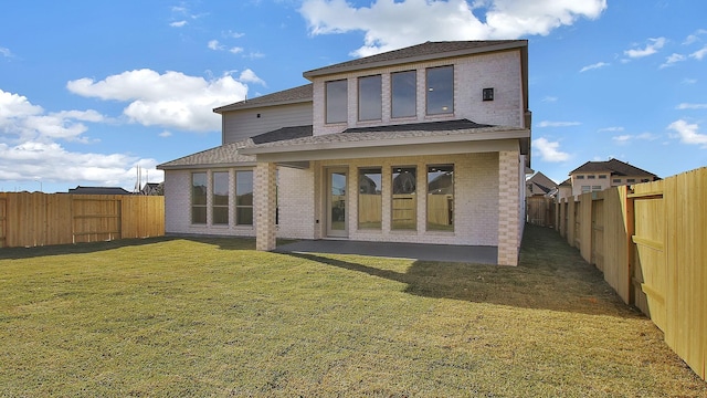 back of property featuring a patio and a lawn