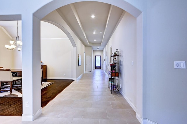 hallway with an inviting chandelier