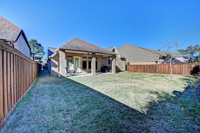 rear view of house featuring a lawn, ceiling fan, and a patio