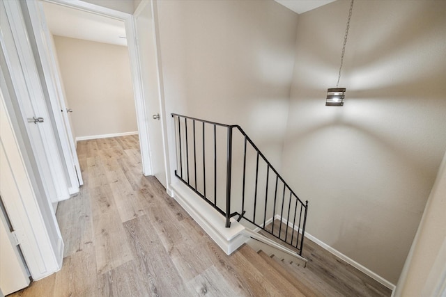 stairs featuring hardwood / wood-style floors