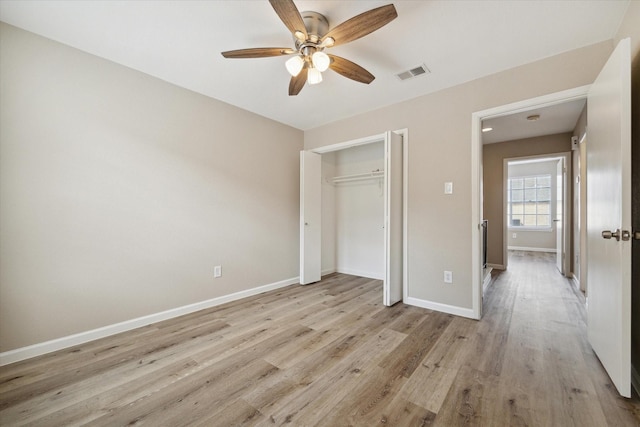 unfurnished bedroom featuring a closet, ceiling fan, and light hardwood / wood-style flooring