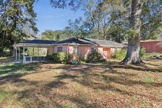 exterior space featuring a carport and a front lawn