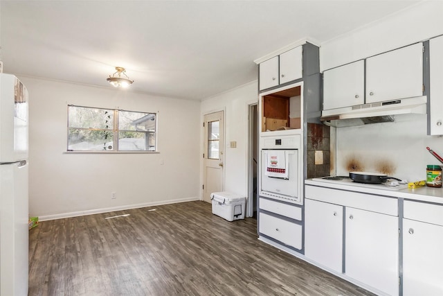 kitchen featuring white appliances, dark hardwood / wood-style floors, and white cabinetry