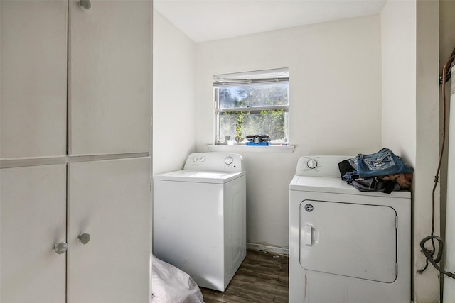 laundry area with cabinets, separate washer and dryer, and dark hardwood / wood-style floors