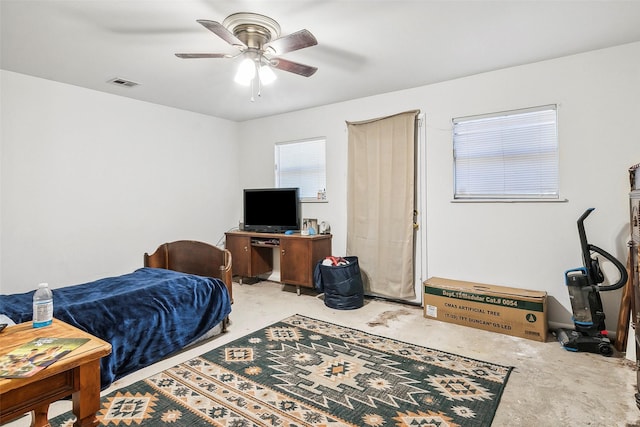 bedroom featuring ceiling fan and concrete floors