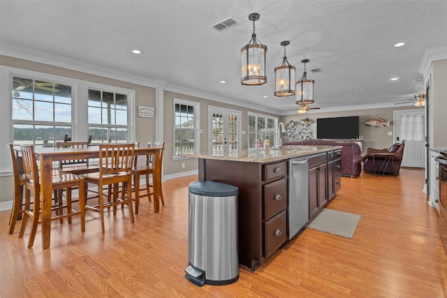 kitchen featuring hanging light fixtures, stainless steel dishwasher, dark brown cabinets, ceiling fan with notable chandelier, and ornamental molding