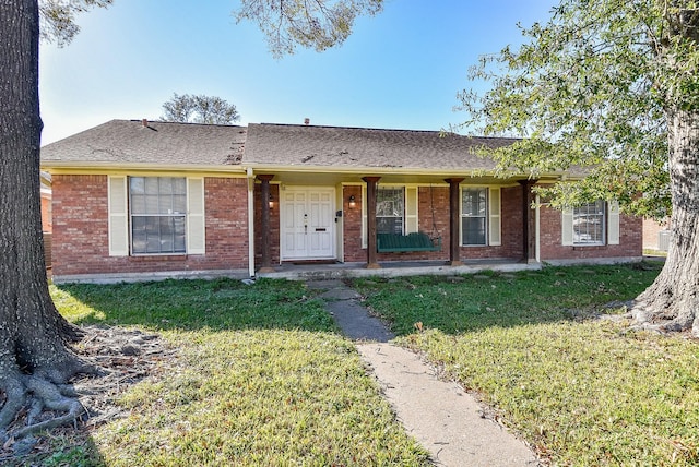 ranch-style home with a front lawn and a porch