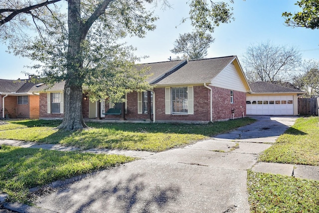 ranch-style house with a garage and a front lawn