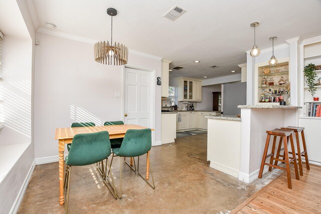 dining space with an inviting chandelier and crown molding