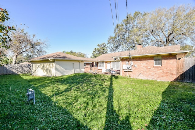 back of property featuring a yard