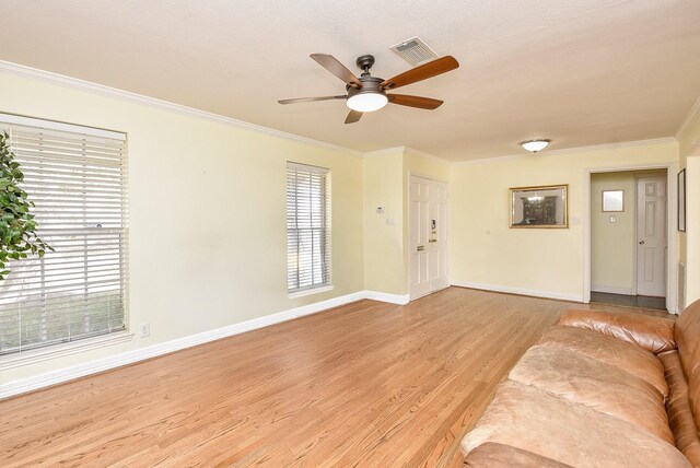 unfurnished living room with ceiling fan, light hardwood / wood-style floors, and ornamental molding