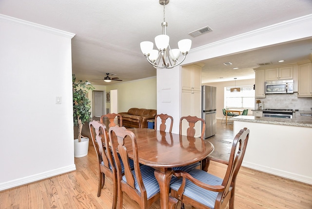 dining area with light hardwood / wood-style flooring, ceiling fan with notable chandelier, and ornamental molding