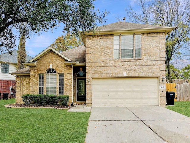 view of front of home with a front yard and a garage