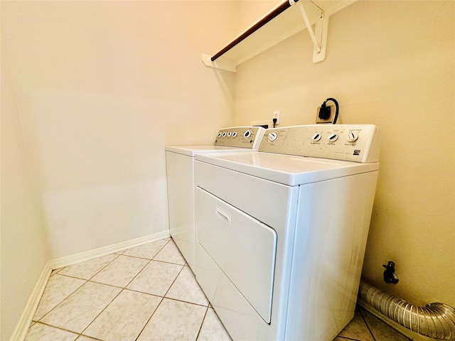 laundry area with light tile patterned floors and independent washer and dryer