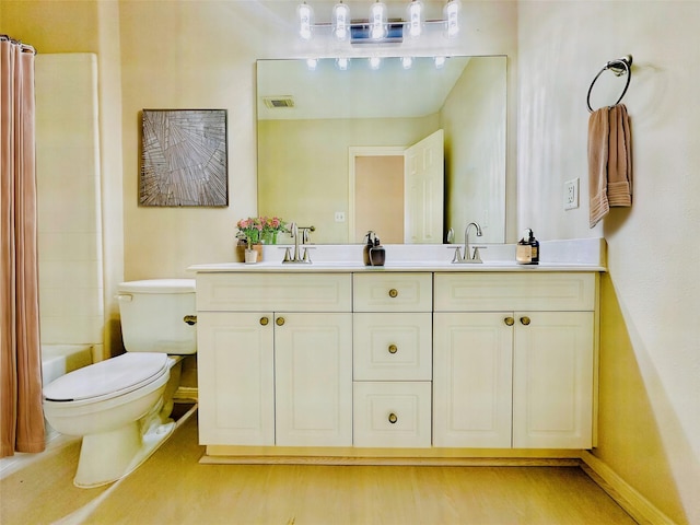 full bathroom with bathing tub / shower combination, hardwood / wood-style floors, vanity, and toilet