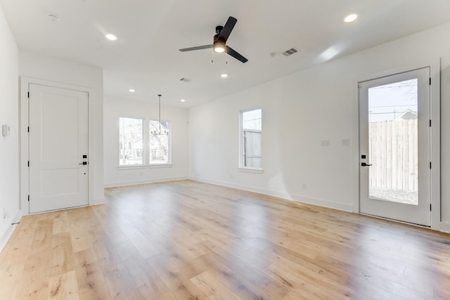 spare room with ceiling fan and light wood-type flooring