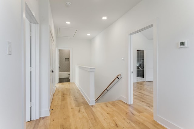 hallway with light hardwood / wood-style floors