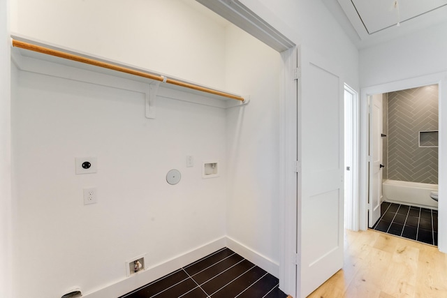 clothes washing area with hookup for a washing machine, light hardwood / wood-style floors, and electric dryer hookup